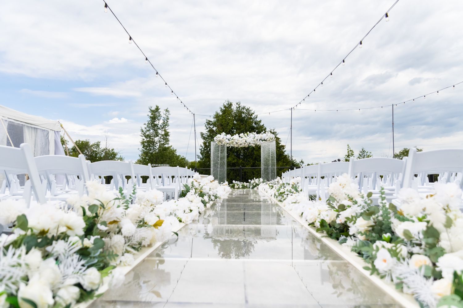 Outdoor Wedding with a raised acrylic walkway and two water columns as the marriage altar. 